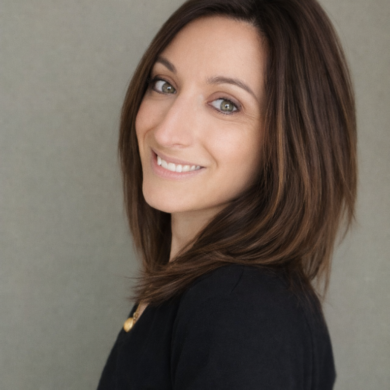 Femme souriante en veste rouge dans un cadre élégant de spa avec des décorations lumineuses.